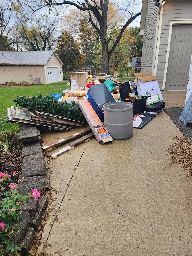Dumpster being loaded with debris for 12 Yard Dumpster Rental in Murphy
